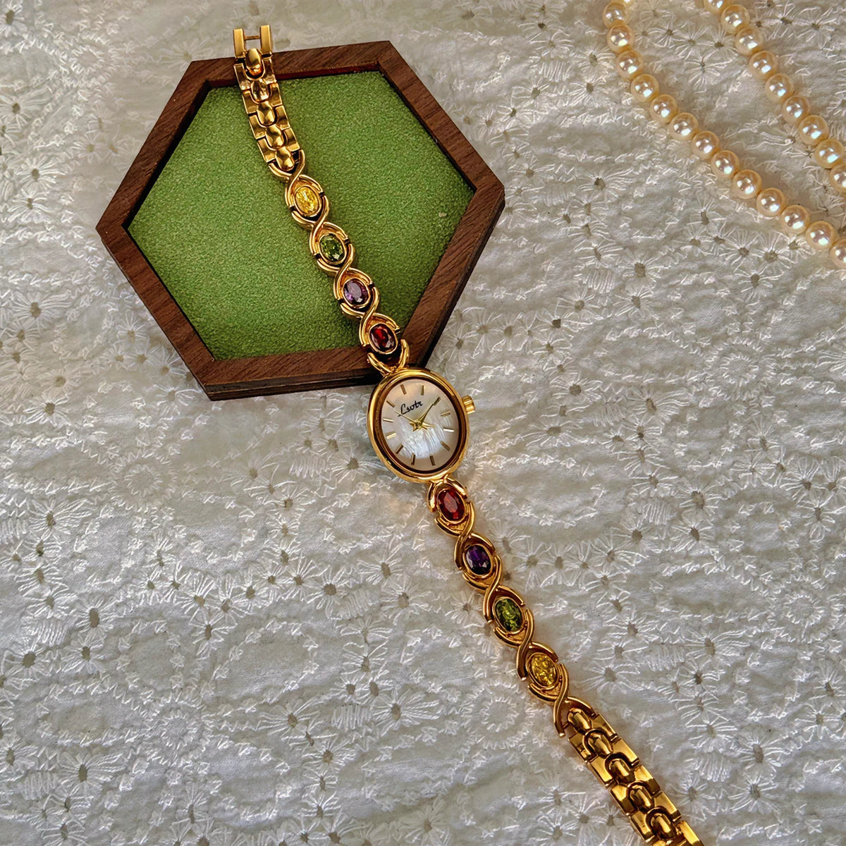 luckacco 1pc new high-end luxury women's watch embedded with colorful tourmalines, diamonds and an oval shaped mother of pearl dial.